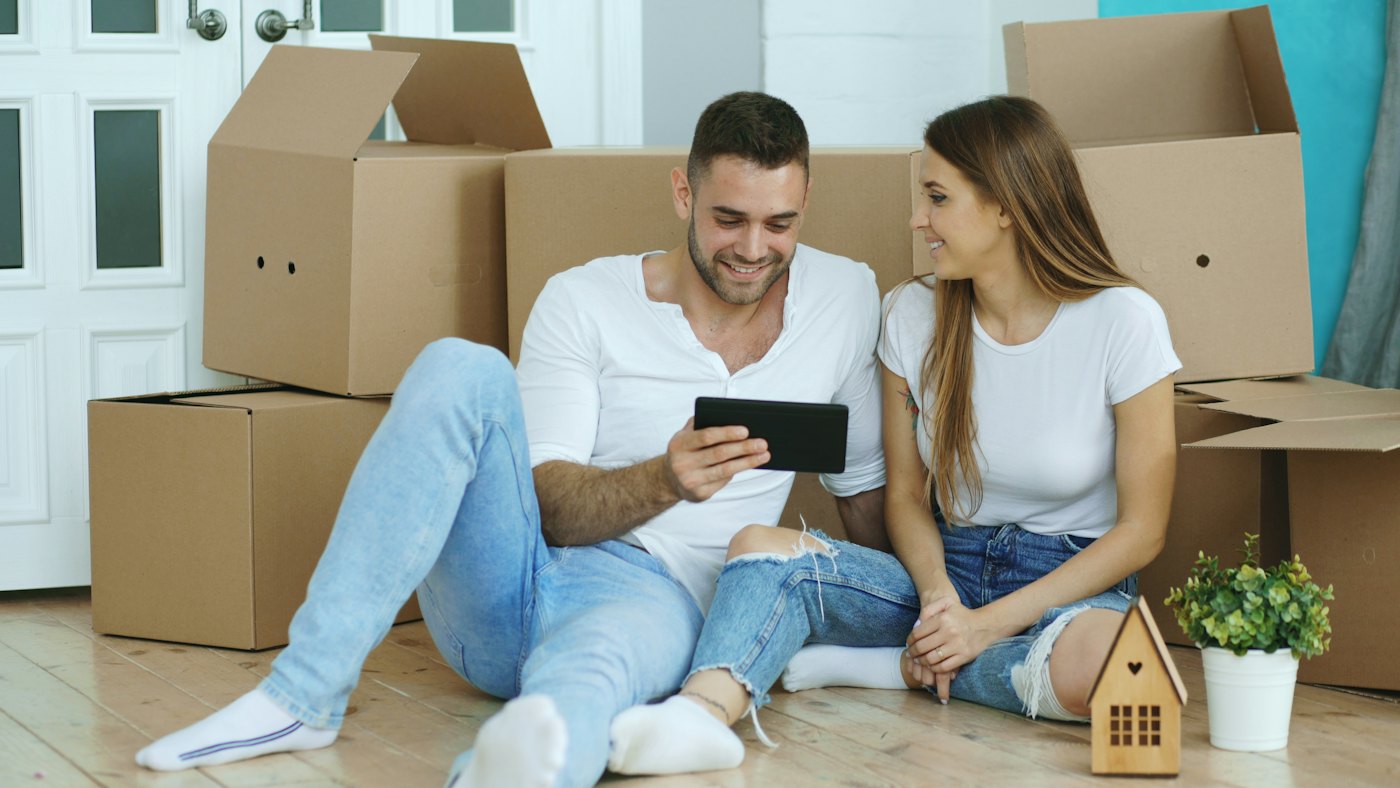 Couple planning their move surrounded by boxes